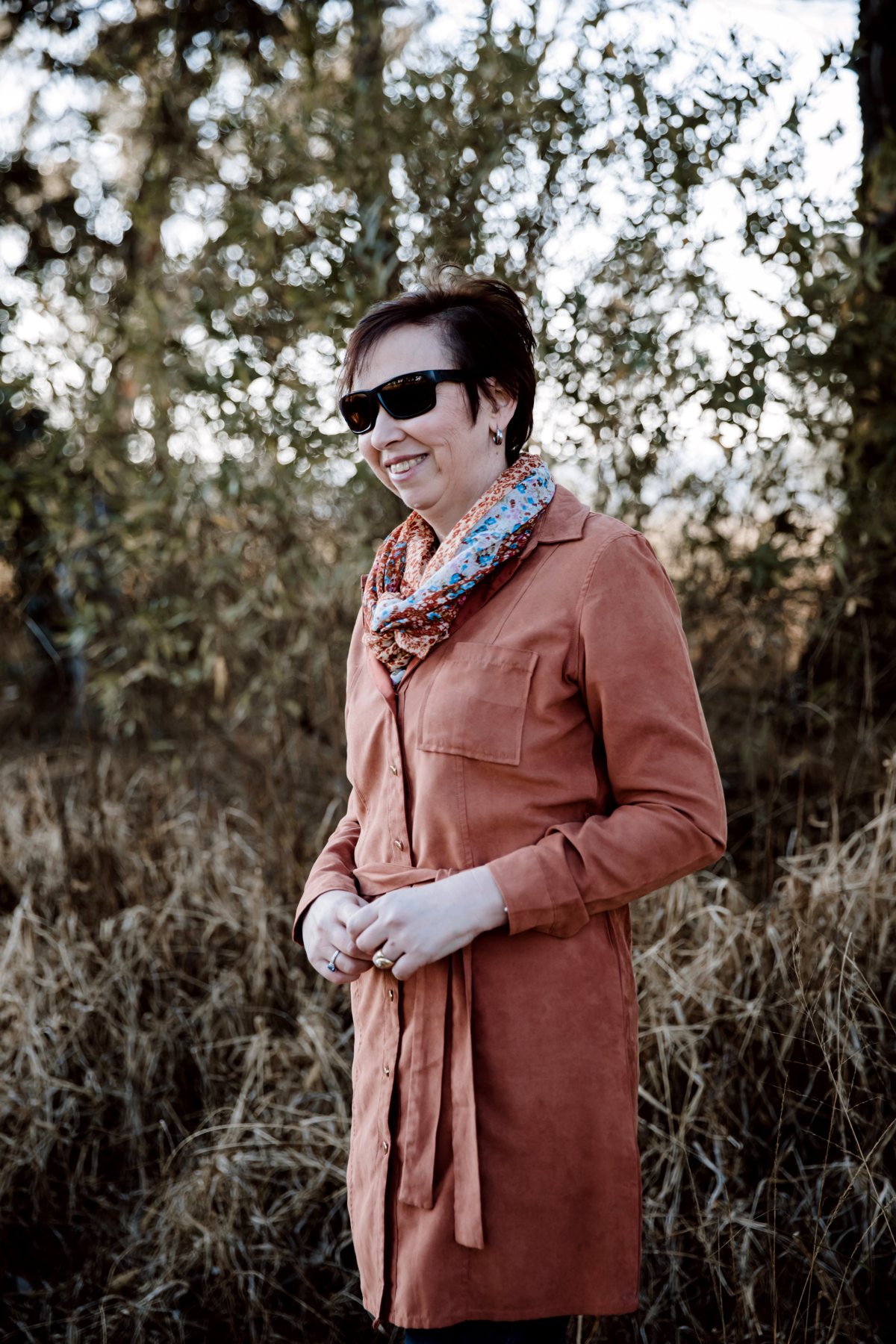 Janine standing in golden veld grass